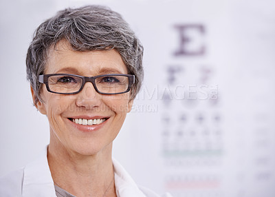 Buy stock photo Portrait of a female optometrist standing beside an eye test poster