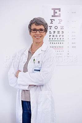 Buy stock photo Mature woman, optometrist and arms crossed for eye care in portrait, test and alphabet chart for vision. Glasses, prescription lens and frame for healthcare, confidence with ophthalmologist at clinic