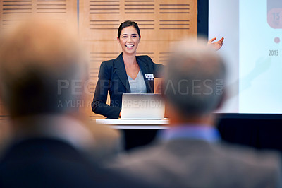 Buy stock photo A happy young businesswoman gesturing while giving a presentation at a press conference