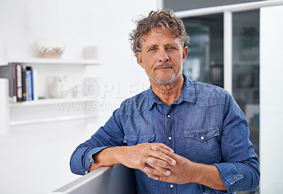 Buy stock photo Portrait of a mature businessman leaning against his desktop computer