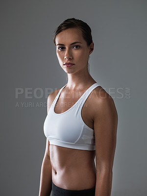 Buy stock photo Woman, serious in portrait and confident for fitness, strong and determined with sweat from workout on grey background. Body, endurance and athlete for sports, exercise with pride and power in studio