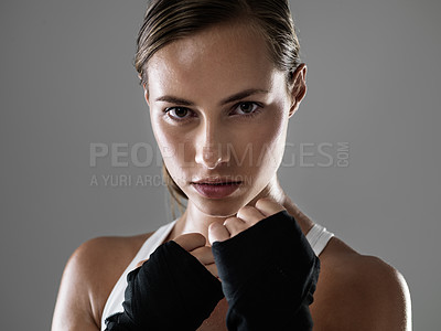 Buy stock photo Cropped shot of an attractive young woman standing in a boxer stance