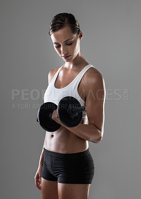Buy stock photo Woman, fitness and weightlifting with dumbbell for muscle gain, workout or exercise on a gray studio background. Active female person or bodybuilder with weight for arm or bicep curl on mockup space
