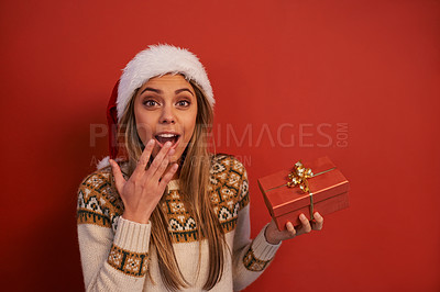 Buy stock photo Surprise woman, portrait and Christmas with gift box for December holiday or festive season on a red studio background. Excited female person with hat, wow or shock for present, prize or mockup space