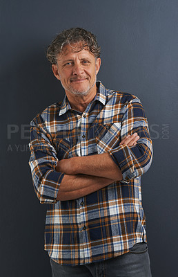 Buy stock photo A portrait of a happy mature man standing with his arms folded