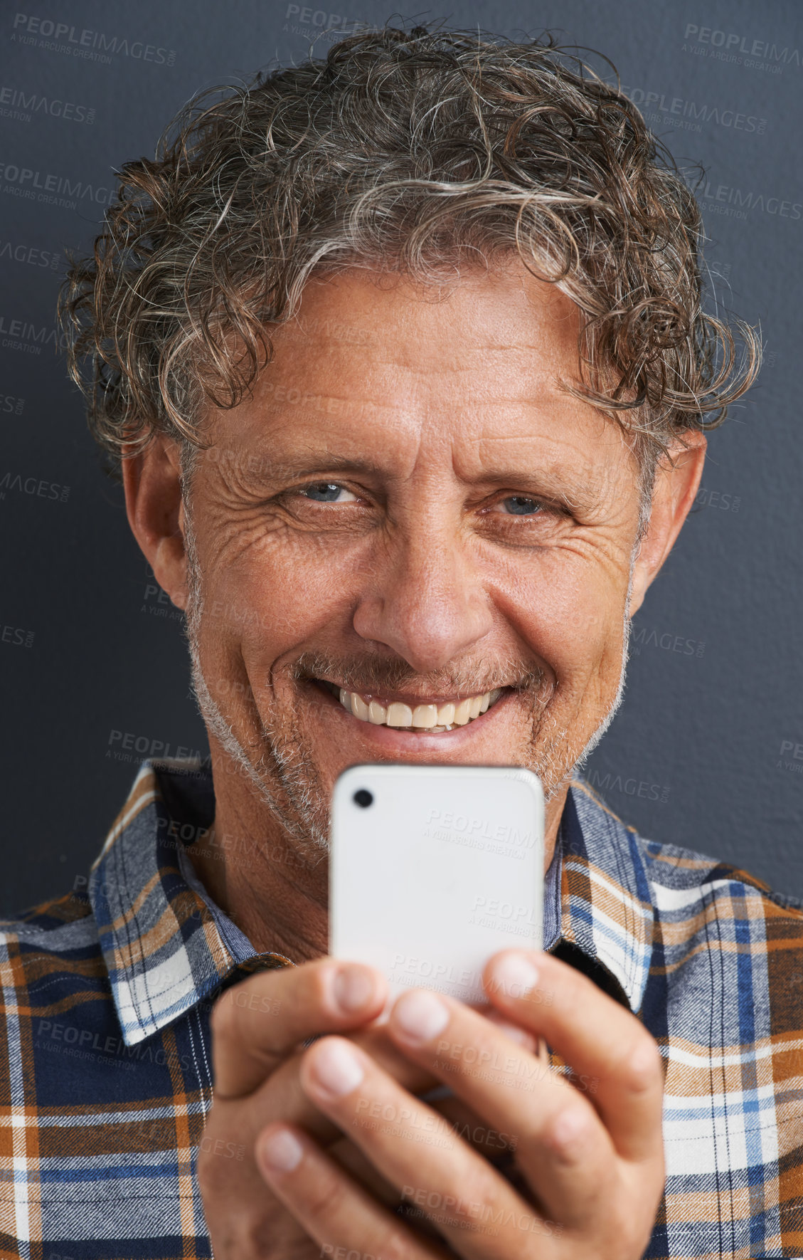Buy stock photo A cropped portrait of a happy mature man taking a photo with his smart phone