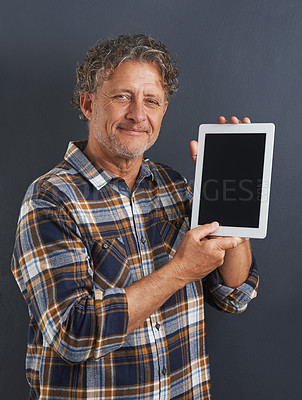 Buy stock photo A portrait of a happy mature man showing a tablet with a blank screen