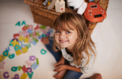 Buy stock photo Girl, child and smile with letter toys for learning, development and games in playroom at home. Portrait, education and growth in childhood with alphabet, language and happy kid playing for fun