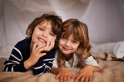 Buy stock photo Happy, blanket fort and portrait of kids relaxing, bonding and playing together at home. Smile, cute and young girl and boy children siblings laying in tent for fun sleepover in bedroom at house.