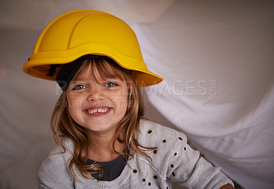 Buy stock photo Child, helmet and bedroom for game, playing and excited in portrait for imagination, creative and adventure. Face of a kid or girl in hard hat on her bed or with blanket at night for construction