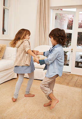 Buy stock photo Shot of two young children playing together in the living room at home