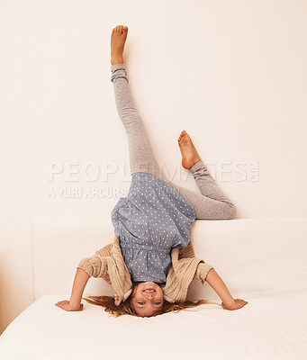Buy stock photo Portrait of a little girl doing a headstand indoors