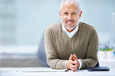 Buy stock photo Portrait of a mature businessman sitting at his office desk