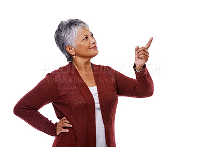 Buy stock photo Studio shot of a mature woman pointing to copyspace isolated on white