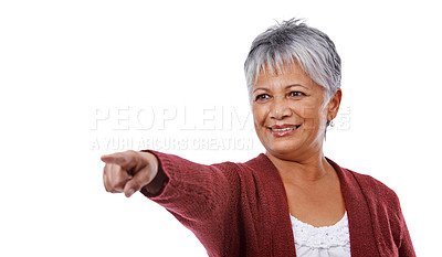 Buy stock photo Studio shot of a mature woman pointing isolated on white