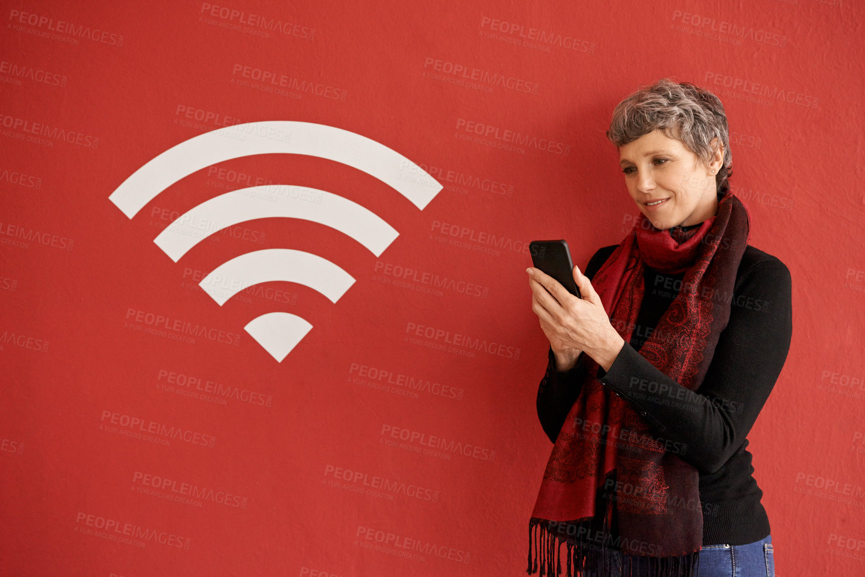 Buy stock photo Senior woman, phone and texting by wall with overlay, icon and wireless network with smile by red background. Mature lady, smartphone and reading on social media, chat and blog with connection sign