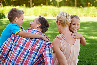 Buy stock photo Mother, father and children hug in garden for family bonding on travel holiday in park for relax, connection or happy. Man, woman and siblings with back on backyard grass in Australia, summer or calm