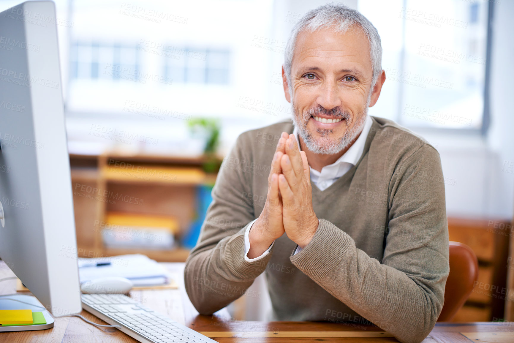 Buy stock photo A portrait of a happy businessman sitting at his desk at work