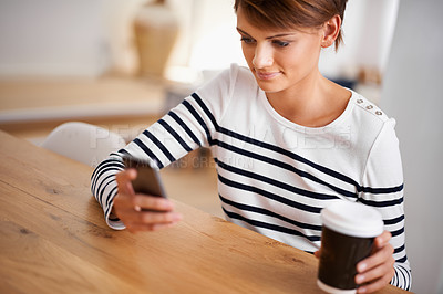 Buy stock photo Cellphone, smile and woman with coffee in dining room networking on social media, mobile app or internet. Happy, technology and female person with cappuccino scroll on a phone at modern apartment.