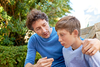 Buy stock photo Family, father talking with son in backyard, bonding with love and care, communication and relationship. Man with sad teen boy, help with advice at home and outdoor together with trust and support