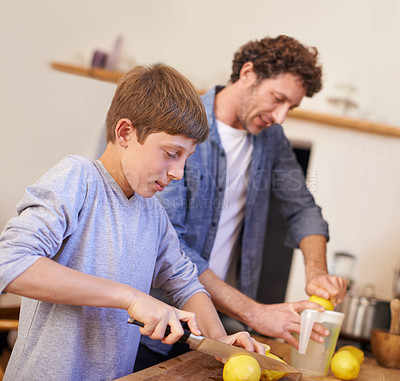 Buy stock photo Father, child and lemon fruit in kitchen for lemonade nutrition for breakfast drink, beverage or wellbeing. Male person, son and juicer equipment in apartment or fresh citrus, vitamin c or gut health