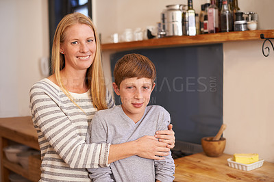 Buy stock photo Mother, son and hug in portrait with smile, happiness and comfort for security with woman and boy relax in kitchen. Family, trust and affection with bonding, childhood with single parent at home