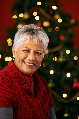 Buy stock photo Christmas, senior and portrait of happy woman in home for holiday celebration by tree with light bokeh. Xmas, face and smile of mature female person in house for festive season or party in Brazil