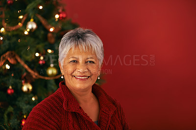 Buy stock photo Christmas, smile and portrait of senior woman in studio for Christian holiday celebration by tree isolated on red background mockup space. Xmas, face or happy female person at festive party in Brazil