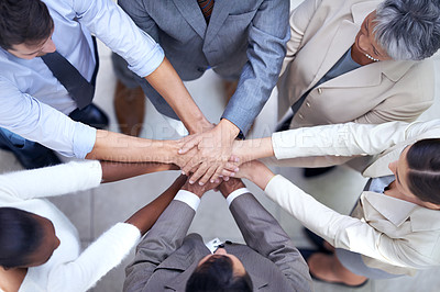 Buy stock photo Shot of a group of coworkers with their hands in a huddle