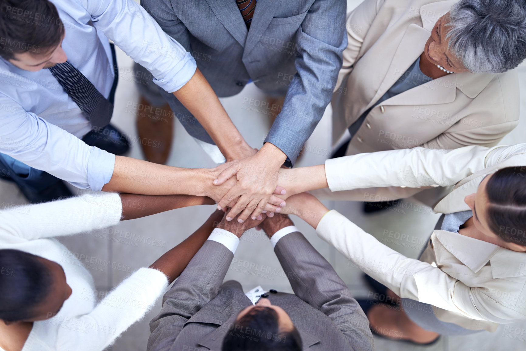 Buy stock photo Shot of a group of coworkers with their hands in a huddle