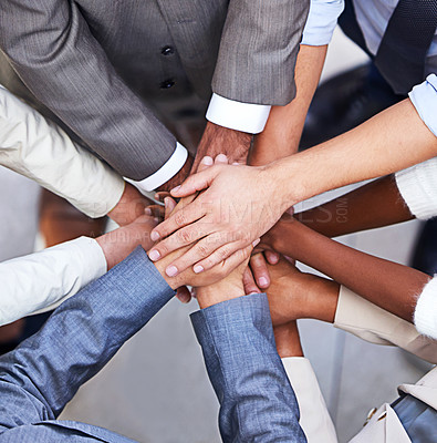 Buy stock photo Cropped shot of a group of businesspeople standing in a huddle with their hands piled up