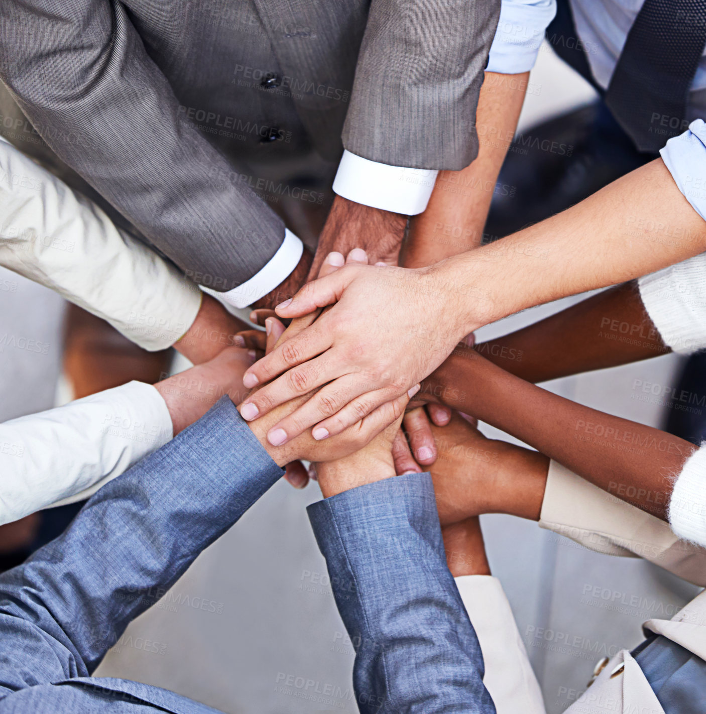 Buy stock photo Cropped shot of a group of businesspeople standing in a huddle with their hands piled up