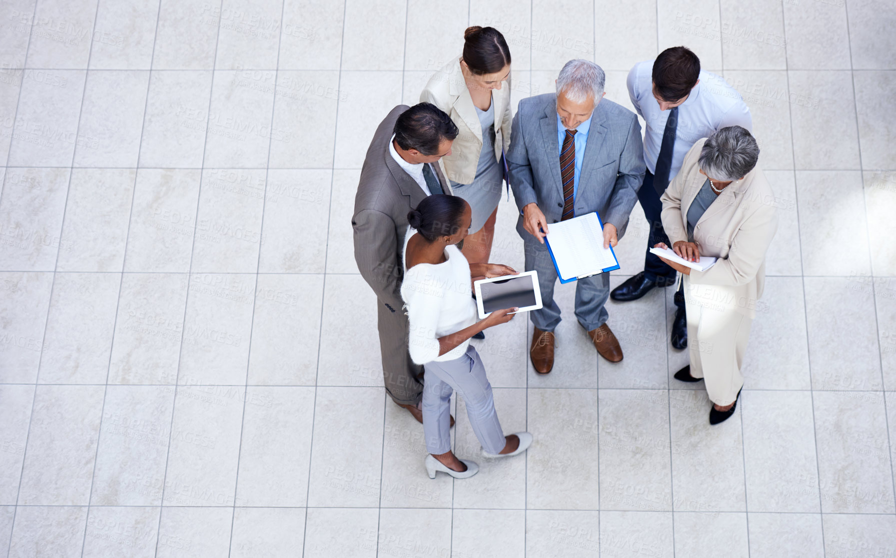 Buy stock photo Documents, tablet and business people in discussion in lobby of office in collaboration. Paperwork, digital technology and high angle of professional financial advisors in meeting for teamwork.