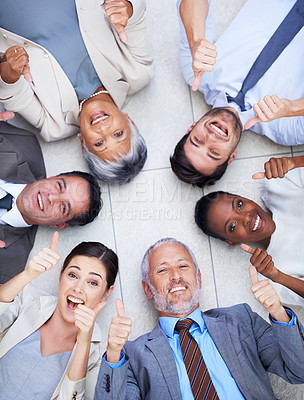Buy stock photo Thumbs up, portrait and team on floor in circle for motivation, agreement and partnership. Business people, diversity and hand with gesture for company success, inspiration and solidarity from above