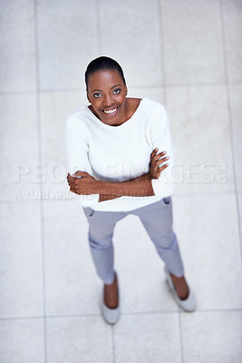 Buy stock photo High angle, portrait and happy woman with arms crossed in business or office with confidence and pride. African, employee and above person in lobby excited for morning in workplace in London