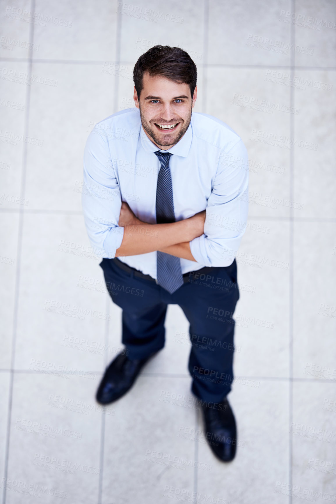 Buy stock photo Business, portrait and high angle of man with arms crossed in office with confidence and pride. Above, entrepreneur and person in lobby to start morning in corporate London workplace with perspective