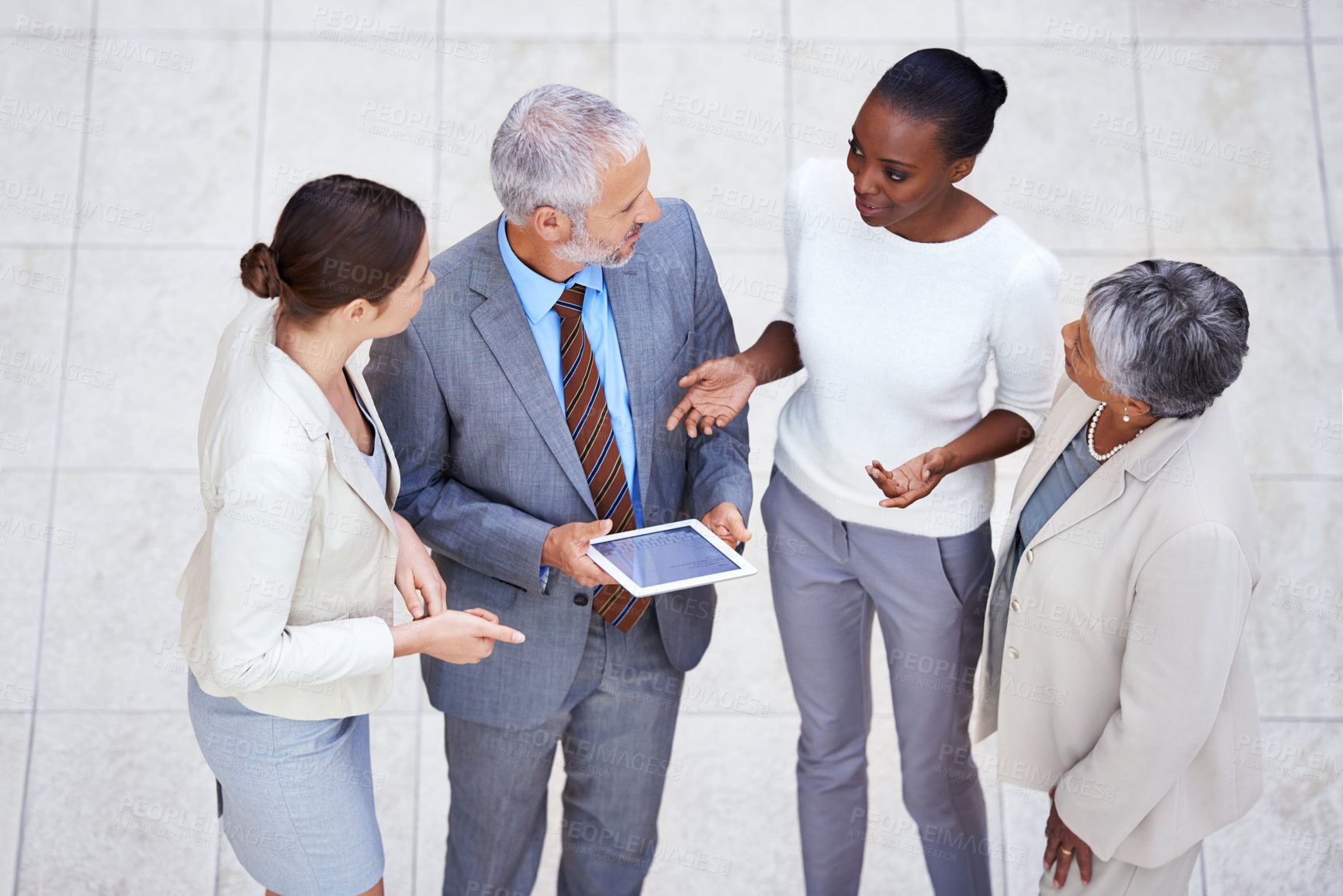 Buy stock photo Discussion, tablet and business people in lobby of office in collaboration for finance project. Meeting, digital technology and high angle of professional financial advisors working on project.