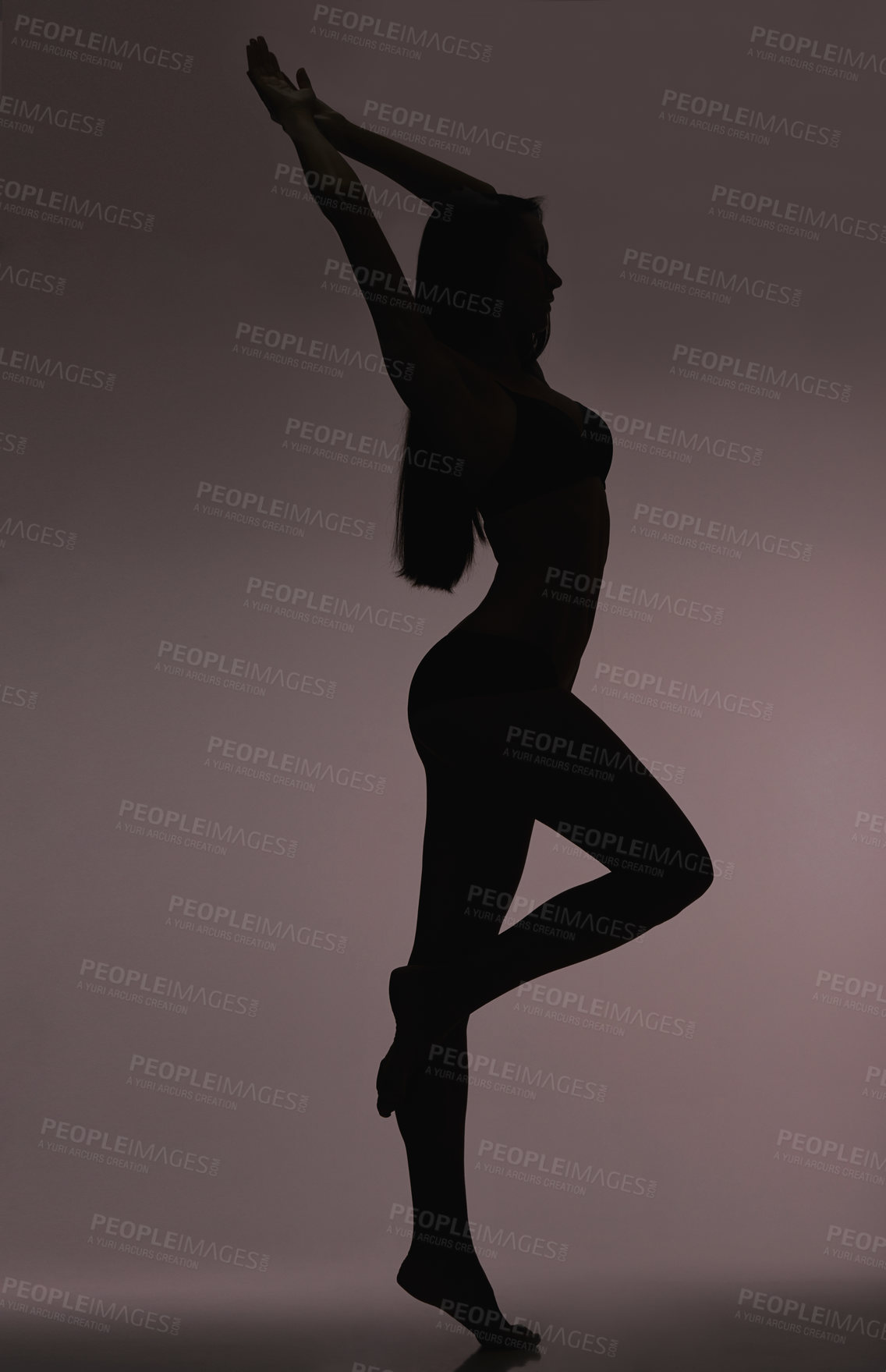 Buy stock photo Slim girl, woman and silhouette with beauty, body care and sensual on a dark studio background. Person, profile and model with shadow figure and seductive with stretching and natural pose with dancer