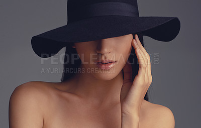 Buy stock photo Studio shot of a beautiful woman wearing a hat against a gray background