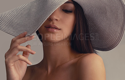 Buy stock photo Beauty, makeup and woman with hat in studio for wellness, cosmetics or glowing skin results on grey background. Fashion, aesthetic and female model with dermatology, shine or stylish confidence 