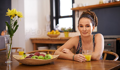 Buy stock photo Portrait of a young woman with dreadlocks sitting at a table with a glass of orange juice