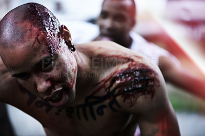 Buy stock photo A cropped shot of a man carrying an injured man to safety