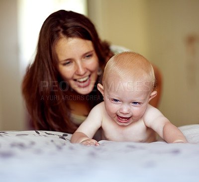 Buy stock photo Laughing, playing and a mother with a baby on the bed for bonding, love and care in the morning. Wake up, smile and a mom with a kid or family together in the bedroom of a house for happiness
