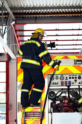Buy stock photo Firefighter, ladder and safety worker with hose truck at a fire station with emergency service employee. Uniform, firetruck and helmet of a fireman ready for rescue working with equipment at a job 