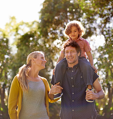 Buy stock photo Parents, nature and carrying child outdoors, love and bonding on summer holiday or vacation. Happy family, shoulders and travel together for security, smile and care in garden or park for enjoyment
