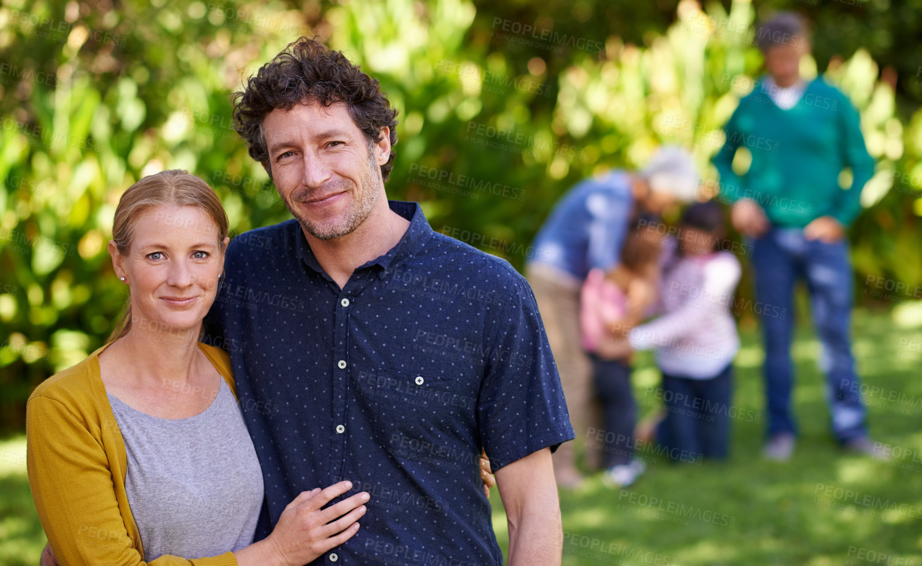 Buy stock photo Portrait, couple and family with hug, garden or happiness with smile or nature with sunshine. Face, people or men with women or embrace with weekend break or summer with vacation or relax in backyard