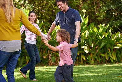 Buy stock photo Happy family, holding hands and kids dance in nature or play game in summer together in circle at park. Ring a rosy, smile and children in garden on holiday, vacation or bonding with parents outdoor