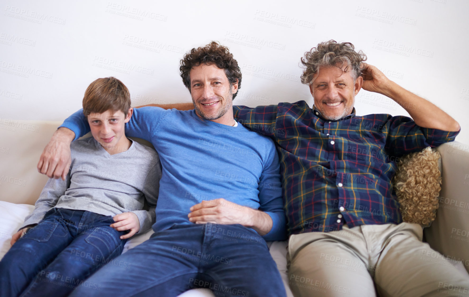 Buy stock photo Portrait of three generations of men sitting on a sofa at home