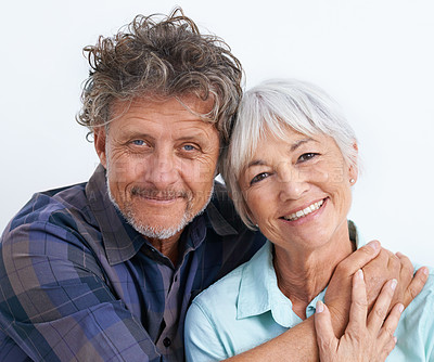 Buy stock photo Old couple, face and hug with happiness in studio, love and security with comfort for bonding. Marriage partner, retirement and smile in portrait, people with trust and loyalty on white background