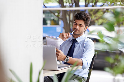 Buy stock photo Laptop, pen and paper for thinking businessman, notepad and outside cafe for online work. Pensive, internet and technology for email for professional male person, notes and reports or paperwork